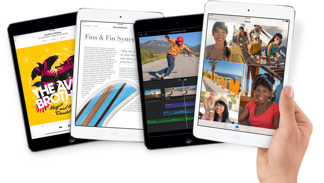 Front view of four iPad mini 2, arranged in a row, with the right most one held by a hand 